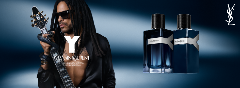 Werbeanzeige für das Parfum 'Y' von Yves Saint Laurent. Links steht ein Mann mit langen Dreadlocks, Sonnenbrille und offenem schwarzen Hemd. Er hält eine E-Gitarre mit einer um den Hals gewickelten Schlange. Vor ihm das große weiße 'Y' und darunter das Yves-Saint-Laurent-Logo mit dem Text 'The Original Eau de Parfum & the New Le Parfum'. Rechts im Bild zwei dunkelblaue Parfumflakons mit silbernem Y-förmigem Band und schwarzem Verschluss. Der Hintergrund ist in dunklem Blau gehalten mit Lichtverlauf.